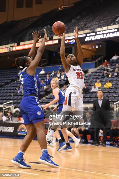 Conor Richardson of the Duquesne Lady Dukes takes a shot over Aaliyah Covington of the Saint Louis Billikens during the quarterfinal round of the...