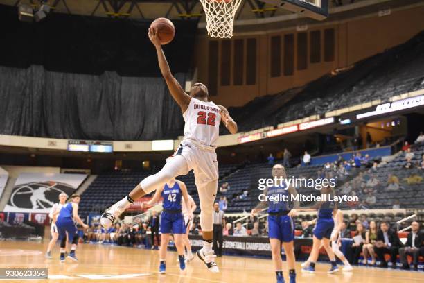 Conor Richardson of the Duquesne Lady Dukes drives to the basket the quarterfinal round of the Atlantic-10 Women's Basketball Tournament against the...