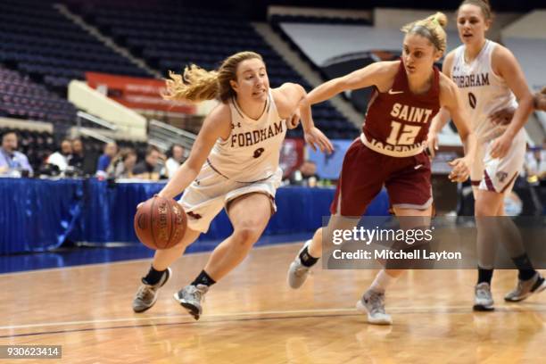 Lauren Holden of the Fordham Lady Rams dribbles around Alyssa Monaghan of the St. Joseph Hawks during the quarterfinal round of the Atlantic-10...