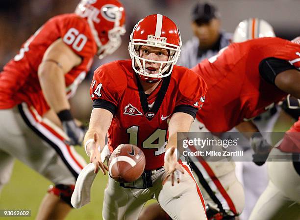 Quarterback Joe Cox of the Georgia Bulldogs pitches the ball back to a running back during the game against the Auburn Tigers at Sanford Stadium on...