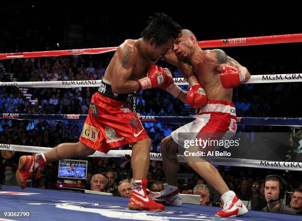 Manny Pacquiao throws a left at Miguel Cotto during their WBO welterweight title fight at the MGM Grand Garden Arena on November 14, 2009 in Las...