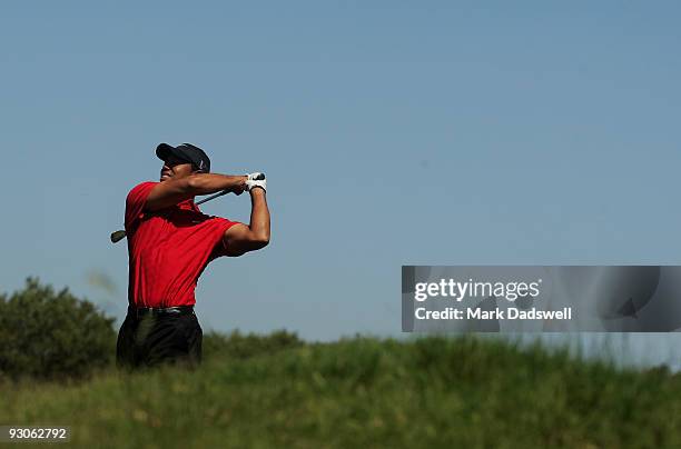 Tiger Woods of the USA plays an approach shot on the 13th hole during the final round of the 2009 Australian Masters at Kingston Heath Golf Club on...