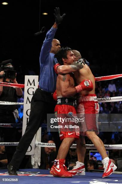 Referee Kenny Bayless ends the fight in the 12th round giving Manny Pacquiao a TKO victory against Miguel Cotto during their WBO welterweight title...