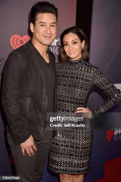 Mario Lopez and Courtney Laine Mazza arrive at the 2018 iHeartRadio Music Awards which broadcasted live on TBS, TNT, and truTV at The Forum on March...