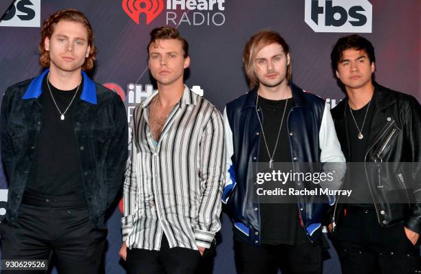 Luke Hemmings, Ashton Irwin, Michael Clifford and Calum Hood of 5 Seconds of Summer arrive at the 2018 iHeartRadio Music Awards which broadcasted...