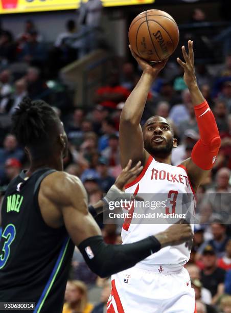 Chris Paul of the Houston Rockets takes a shot against Nerlens Noel of the Dallas Mavericks at American Airlines Center on March 11, 2018 in Dallas,...