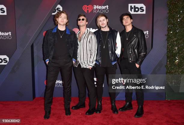 Ashton Irwin, Luke Hemmings, Michael Clifford, and Calum Hood of 5 Seconds of Summer arrive at the 2018 iHeartRadio Music Awards which broadcasted...