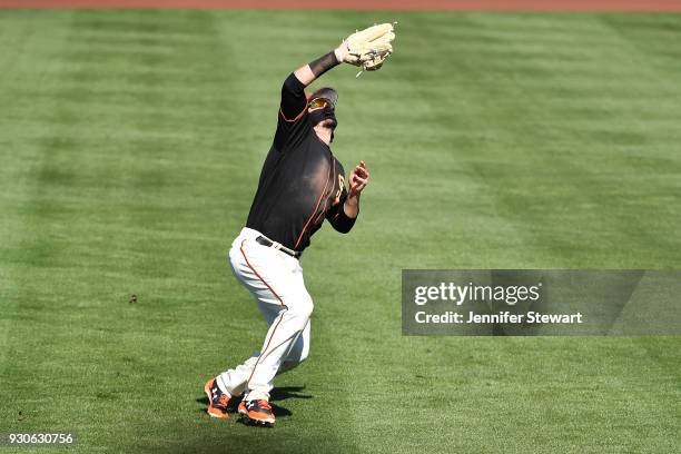 Jarrett Parker of the San Francisco Giants catches a fly ball in the spring training game against the Kansas City Royals at Scottsdale Stadium on...