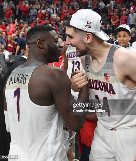 Rawle Alkins and Dusan Ristic of the Arizona Wildcats celebrate after defeating the USC Trojans 75-61 to win the championship game of the Pac-12...