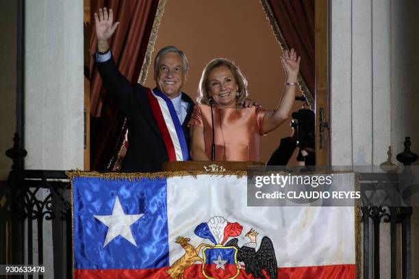 Chilean President Sebastian Pinera , waves next to his wife Cecilia Morel from the balcony at La Moneda presidential palace in Santiago on 11 March,...