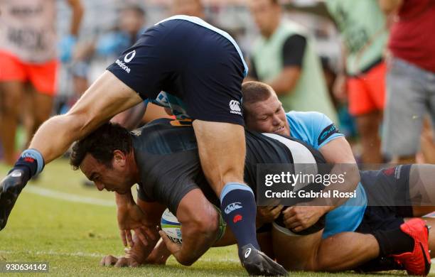 Agustin Creevy of Jaguares is tackled by Damien Fitzpatrick of Waratahs during a match between Jaguares and Waratahs as part of fourth round of Super...