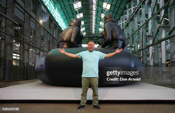 Ai Weiwei poses in front of his work 'Law of the Journey' on March 12, 2018 in Sydney, Australia. The 60m rubber raft installation features over 300...