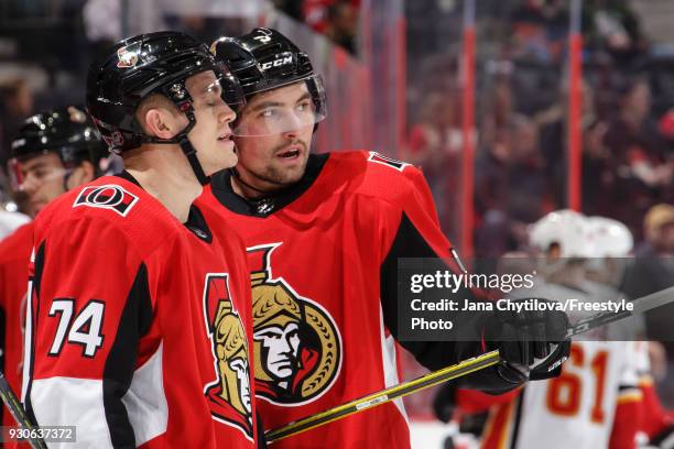 Teammates Cody Ceci and Mark Borowiecki of the Ottawa Senators chat during a break in the game against the Calgary Flames at Canadian Tire Centre on...