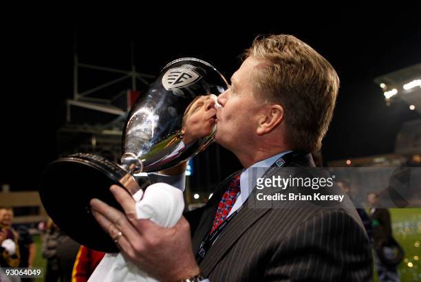 Real Salt Lake owner Dave Checketts kisses the Eastern Conference trophy after his team defeated the Chicago Fire in the MLS Eastern Conference...