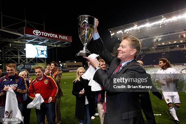 Real Salt Lake owner Dave Checketts hoists the Eastern Conference trophy after his team defeated the Chicago Fire in the MLS Eastern Conference...