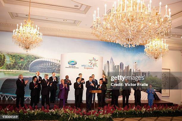 Singapore's Prime Minister Lee Hsien Loong speaks surrounded by APEC Leaders at the declaration ceremony at the end of the the APEC Summit on...