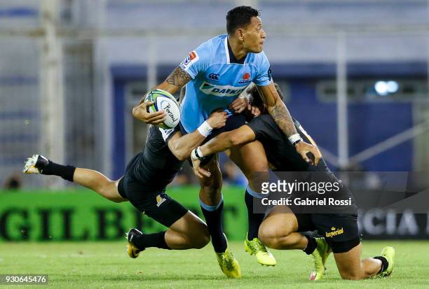 Israel Folau of Waratahs is tackled by Joaquin Tuculet of Jaguares during a match between Jaguares and Waratahs as part of fourth round of Super...