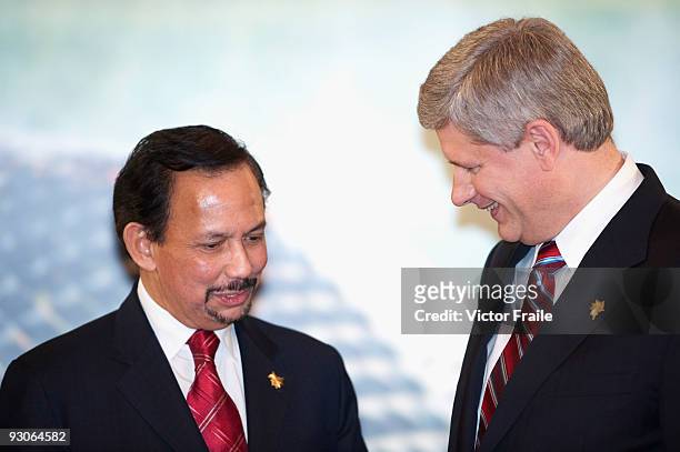 Brunei Sultan Hassanal Bolkiah and Canada's Prime Minister Stephen Harper talk before the declaration ceremony at the end of the the APEC Summit on...
