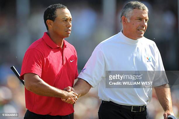 Tiger Woods of the US shakes hands with his caddie Steve Williams after winning the Australian Masters golf tournament during the final round at the...