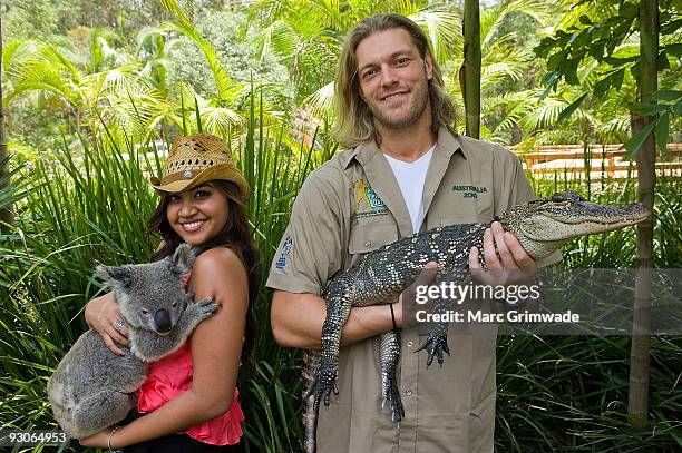 Jessica Mauboy cuddles a koala and WWE Superstar Edge nurses an alligator during Steve Irwin Day celebrations at Australia Zoo on November 15, 2009...