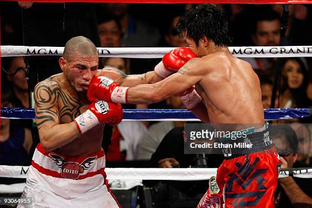 Miguel Cotto of Puerto Rico and Manny Pacquiao exchange blows during their WBO welterweight title fight at the MGM Grand Garden Arena on November 14,...