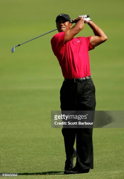 Tiger Woods of the USA plays an approach shot on the 18th hole during the final round of the 2009 Australian Masters at Kingston Heath Golf Club on...