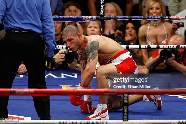 Miguel Cotto of Puerto Rico gets up from the mat after being knocked down in the fourth round before losing to Manny Pacquiao by 12th round TKO...