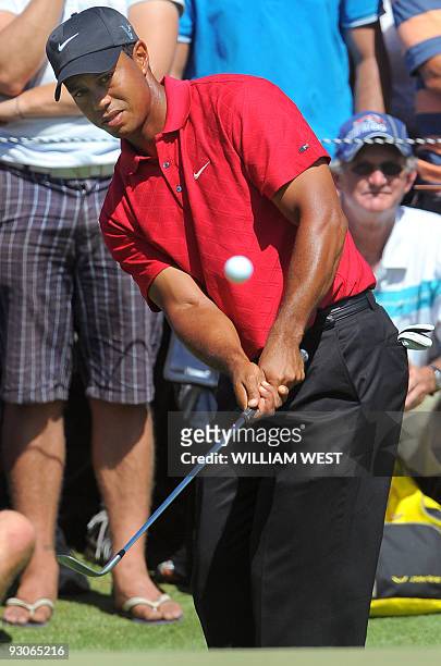 Tiger Woods of the US chips the ball onto the green on the way to winning the Australian Masters golf tournament during the final round at the...