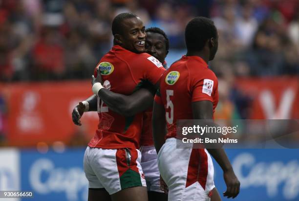 Willy Ambaka hugs Oscar Ouma and Billy Odhiambo of Kenya after scoring a try against Fiji during the gold medal game at Canada Sevens, the Sixth...