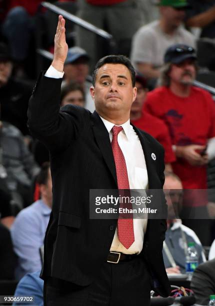Head coach Sean Miller of the Arizona Wildcats signals his players during a semifinal game of the Pac-12 basketball tournament against the UCLA...