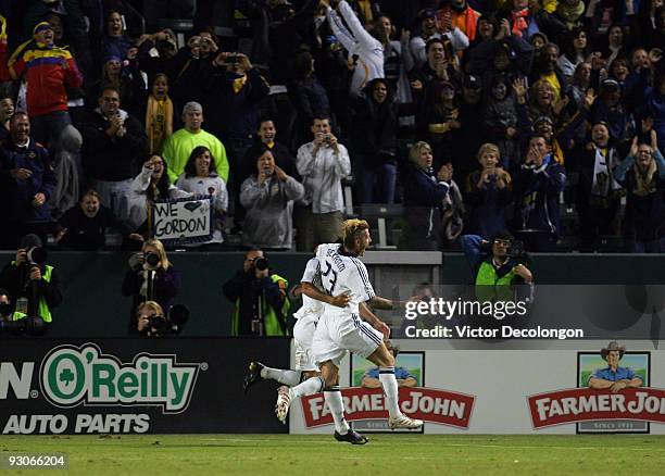 David Beckham of the Los Angeles Galaxy celebrates with teammate Landon Donovan after Donovan converted a penalty kick for a goal to take a 2-0 lead...