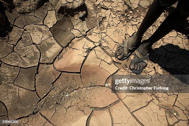 Young boy from the remote Turkana tribe in Northern Kenya stands on a dried up river bed on November 9, 2009 near Lodwar, Kenya. Over 23 million...