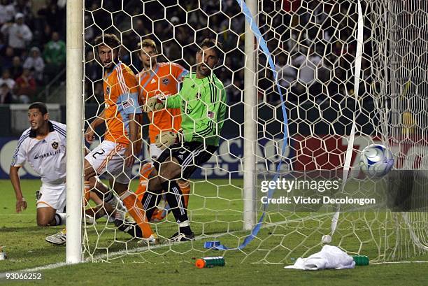 Goalkeeper Pat Onstad and defender Eddie Robinson of the Houston Dynamo can only watch as the ball goes in the net for a goal by Gregg Berhalter of...