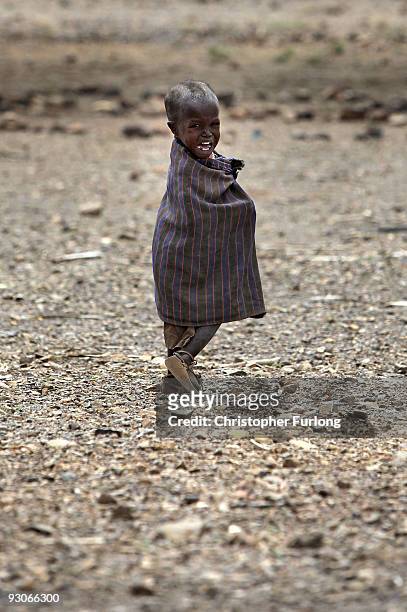 Distressed young girl from the Turkana tribe in Northern Kenya looks for her mother on November 9, 2009 near Lodwar, Kenya. Over 23 million people...