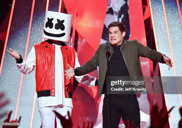 Marshmello and Adam DeVine speak onstage during the 2018 iHeartRadio Music Awards which broadcasted live on TBS, TNT, and truTV at The Forum on March...