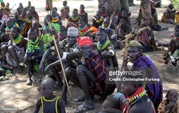 Men and women from the remote Turkana tribe in Northern Kenya wait their turn to see if they will be selected for food aid by other villagers at...