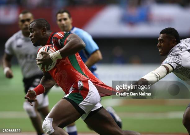 Willy Ambaka of Kenya runs with the ball against Kalione Nasoko of Fiji during the gold medal game at Canada Sevens, the Sixth round of the HSBC...