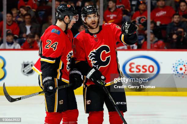 Travis Hamonic and Michael Frolik of the Calgary Flames have a discussion during an NHL game against the New York Islanders on March 11, 2018 at the...