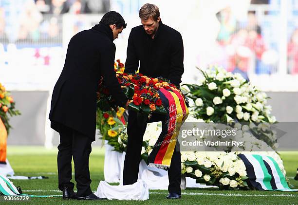 Michael Ballack and Per Mertesacker lay down a wreath at the coffin of their goalie Robert Enke at a memorial service prior to Enke�s funeral at AWD...