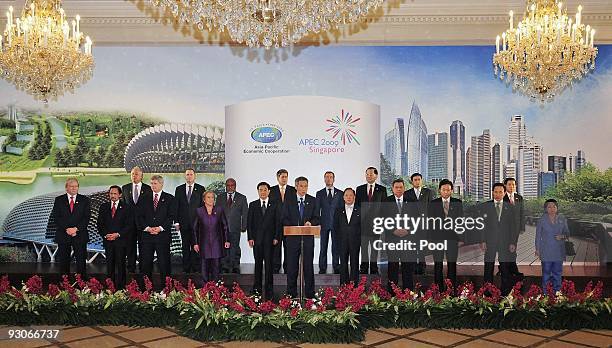 Singapore's Prime Minister Lee Hsien Loong speaks surrounded by APEC Leaders at the closing declaration ceremony of the APEC Summit on November 15 in...