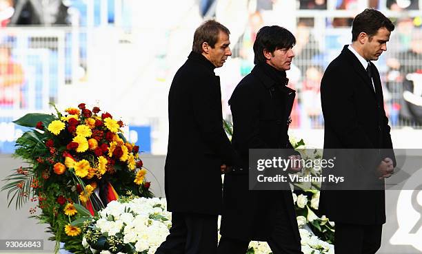 Juergen Klinsmann, Joachim Loew and Oliver Bierhoff leave the coffin of their goalie Robert Enke at a memorial service prior to Enke�s funeral at AWD...