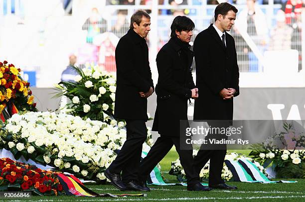 Juergen Klinsmann, Joachim Loew and Oliver Bierhoff leave the coffin of their goalie Robert Enke at a memorial service prior to Enke�s funeral at AWD...