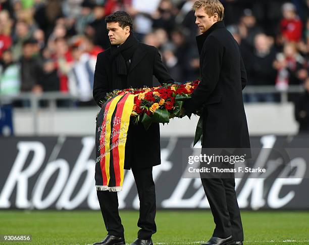Michael Ballck and Per Mertesacker carry a wreath during Robert Enkes funeral at AWD Arena on November 15, 2009 in Hanover, Germany. Tens of...