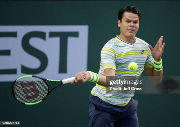 Milos Raonic of Canada returns a forehand to Felix Auger Aliassime of Canada during the BNP Paribas Open on March 11, 2018 at the Indian Wells Tennis...