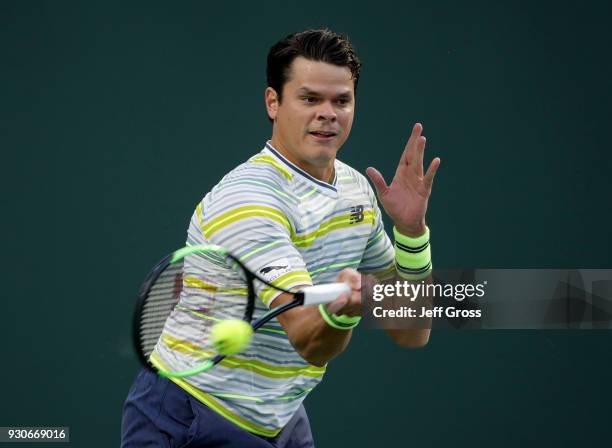 Milos Raonic of Canada returns a forehand to Felix Auger Aliassime of Canada during the BNP Paribas Open on March 11, 2018 at the Indian Wells Tennis...