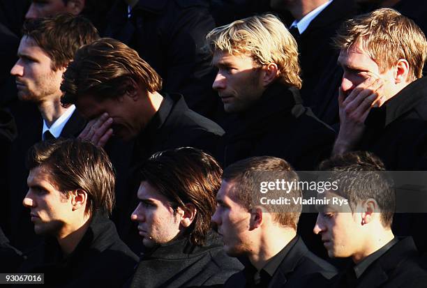 Rene Adler and Per Mertesacker force with the tears at their team mate's Robert Enke memorial service prior to Enke�s funeral at AWD Arena on...