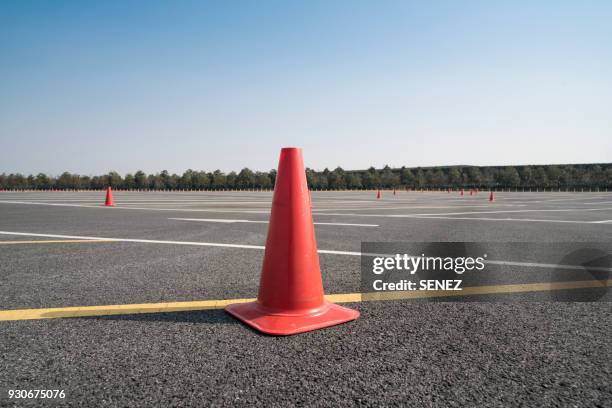 traffic cone,an image of cautions on asphalt road - safety cone stock-fotos und bilder