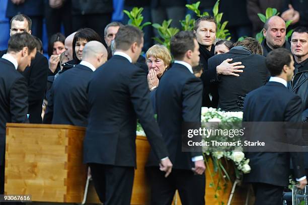 Widow Teresa Enke cries while the coffin of Robert Enke is brought out by players of Hannover 96 during the memorial service prior to Robert Enke's...