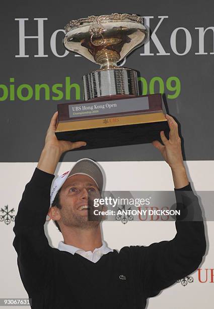 Gregory Bourdy of France holds up the winner's trophy after winning the Hong Kong Open golf tournament at the Hong Kong Golf Club in Fanling on...