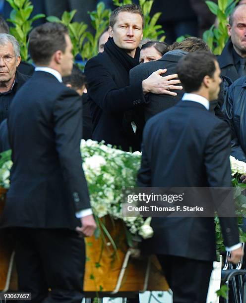 Widow Teresa Enke cries while the coffin of Robert Enke is brought out by players of Hannover 96 during the memorial service prior to Robert Enke's...